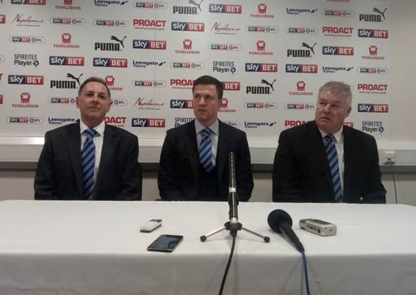 Chesterfield's new boss Gary Caldwell, centre, flanked by company director Ashley Carson, left, and Chris Turner, right