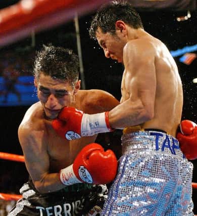 Mexico's Marco Antonio Barrera, right, lands a left to the chin of Erik Morales in the 11th round of their WBC featherweight title fight at the MGM Grand Hotel and Casino in Las Vegas, Saturday, June 22, 2002. Barrera went on to win the bout by unanimous decision. (AP Photo/Laura Rauch)