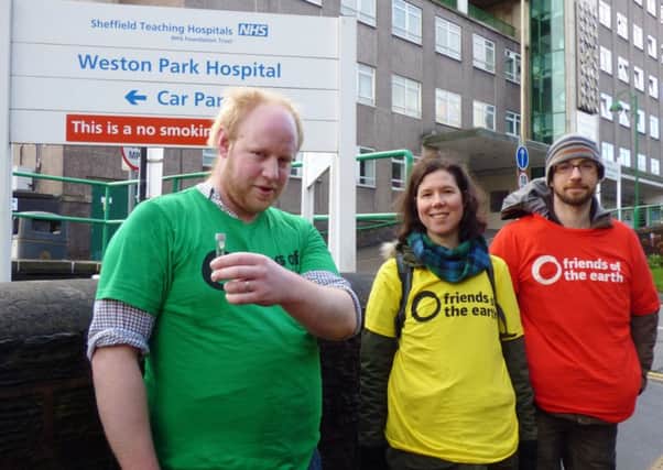 Members of Sheffield Friends of the Earth installing a diffusion tube outside Sheffield hospitals to highlight the impact air pollution has on the health of both children and adults.