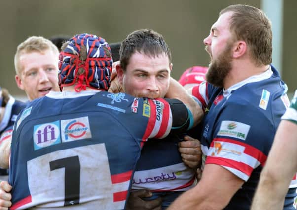 Aaron Carpenter is congratulated on his try on his debut. Picture Scott Merrylees