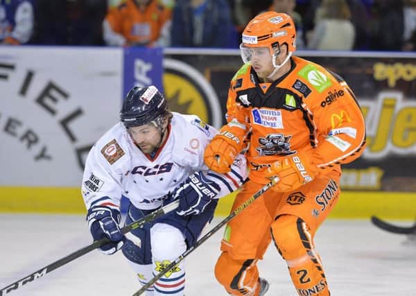 Anders Franzon, Sheffield Steelers defenceman holds off a Dundee challenger. Pic: Dean Woolley