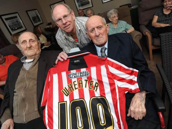 Frank (right) on his 100th birthday with his brother Horace and former Sheffield United defender Ted Hemsley.