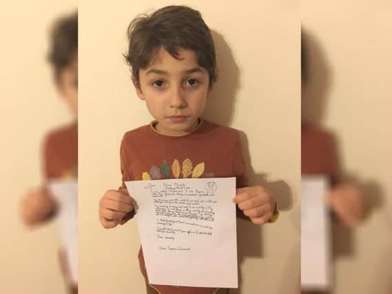 Oliver Greenwood, eight, with his letter to Prime Minister Theresa May about fracking in Derbyshire.