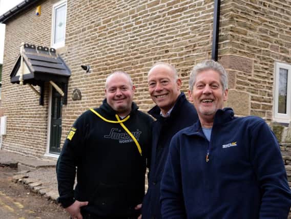 Nick Gregory, Mark Leeming and Myron Abramiuk of Rotary Developments outside the restored Cobnar Cottage.