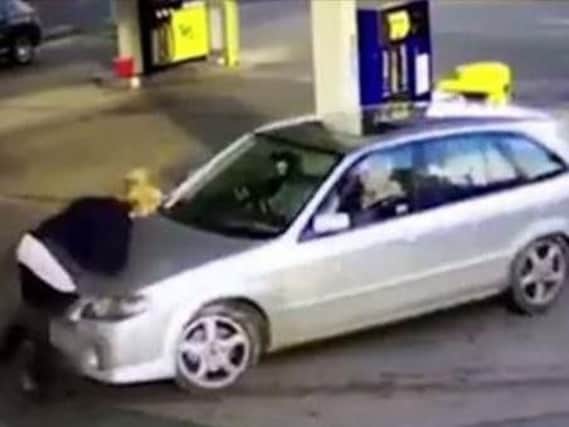 A man has been jailed for crashing into a petrol station attendant