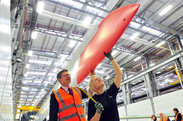 1 December 2016....... Secretary of State Greg Clarke MP with employee Fiona Wright with the first blade on show at the opening of Siemens Wind Turbine Blade Factory in Hull.   Picture Tony Johnson.