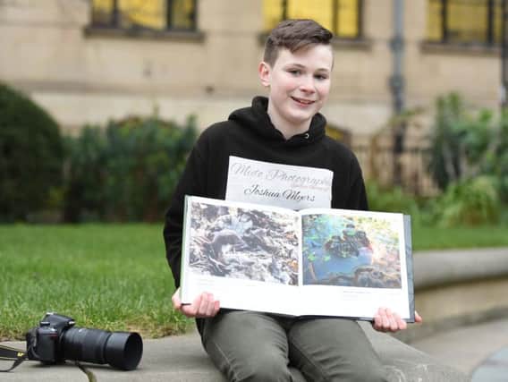 Young Sheffield photographer Josh Myers with his photo published in the British Wildlife Photography Awards book