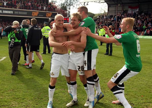 James Coppinger celebrates winning the League One title in 2013 after an incredible finish to the game at Brentford.