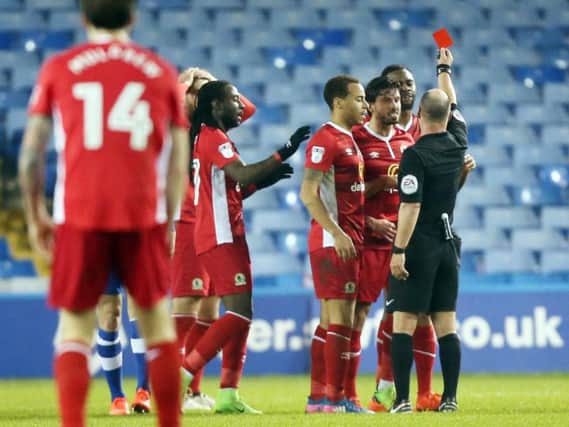 Hope Akpan was sent off against Sheffield Wednesday for placing his hands on referee Scott Duncan