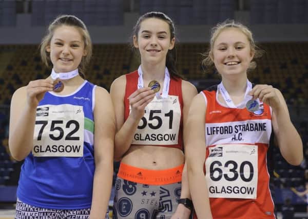 Erin Lobley, centre, on the podium after her shot put gold at the Scottish National Indooors in Glasgow. Photo: Bobby Gavin