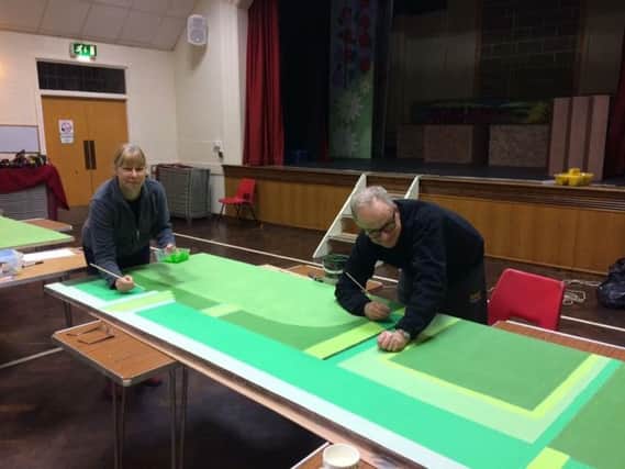 Sheffield's mistress and master cutlers, Julie and Richard Edwards, prepare the backdrops for this year's performance Stephen Hill Youth Pantomime