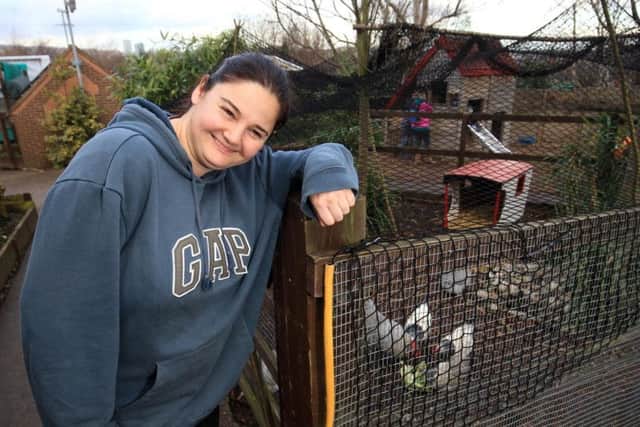 Heeley City Farm's Rachel Griffiths besides the birds which are being kept under protective netting there