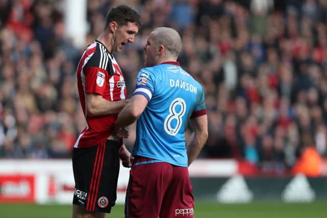 Chris Basham hasd a word with Stephen Dawson of Scunthorpe United: Jamie Tyerman/Sportimage