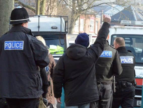 Police lead away tree protesters following their arrest in Chippinghouse Road, Nether Edge