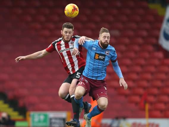 Sheffield United's Jack O'Connell jumps for the ball in the Blades 1-1 draw with Scunthorpe United. Pic: Simon Bellis/SportImage
