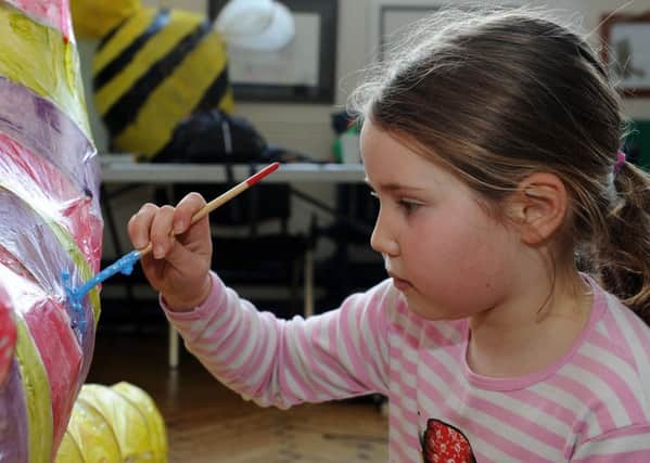 Daisy Kirby-Barker, eight, decorates her lantern for the Ugly Bug Ball in Sharrow. Picture: Andrew Roe