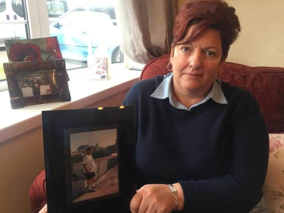 Jackie Perry with a picture of her dad Tommy Ward