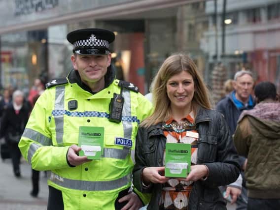 Sergeant Matthew Burdett of Sheffield Business Improvement District and Lucy King, store manager at Marks and Spencer, with the credit card defender sleeves.