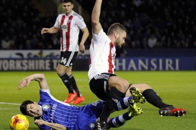No penalty Owls Fernando Forestieri tangles with Bees Harlee Dean in the box....Pic Steve Ellis