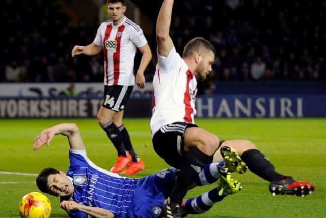 Fernando Forestieri goes down after a tangle with Harlee Dean but is not awarded a penalty