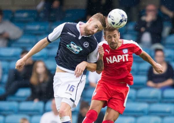Millwall vs Chesterfield - Angel Martinez goes up for a header with Millwall's Mark Beevers - Pic By James Williamson