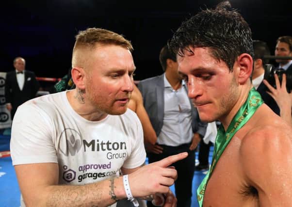 Gavin McDonnell, with Stefy Bull, appears dejected after losing to Rey Vargas  in the WBC Super Bantamweight Championship bout at Hull Ice Arena.