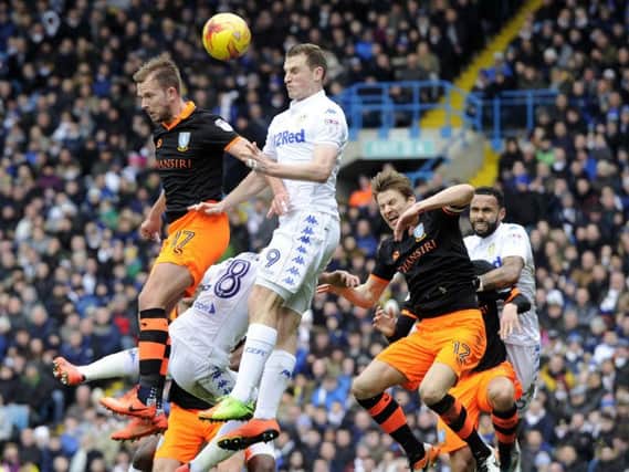 Jordan Rhodes jumps with Chris Wood in Sheffield Wednesday's clash with Leeds United at Elland Road