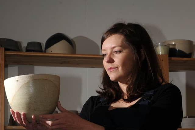 Francesca Hague, of Grey Suit Clay, with piece of her clay work.
