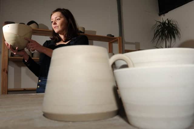 Francesca Hague, of Grey Suit Clay, with piece of her clay work.