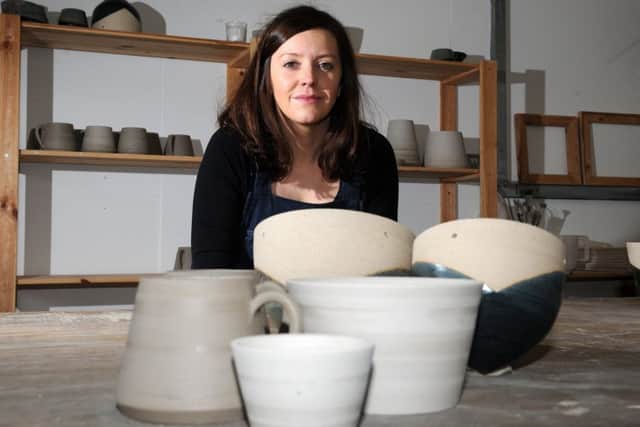 Francesca Hague, of Grey Suit Clay, with piece of her clay work.