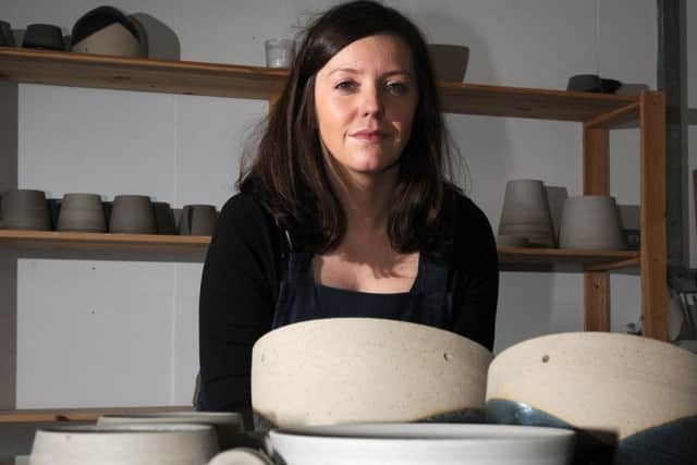 Francesca Hague, of Grey Suit Clay, with piece of her clay work.
