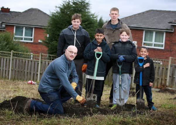 Great Places Community Development Co-Ordinator Phillip Walker planting a fruit tree at Maltravers Terrace Community Orchard with local volunteers Benjamin Shooter (13), Benul Rathnam (12), Ewan Page, Joseph Shooter (9) and Bevin Rathnam (6).

credit:  leeboswellphotography.com