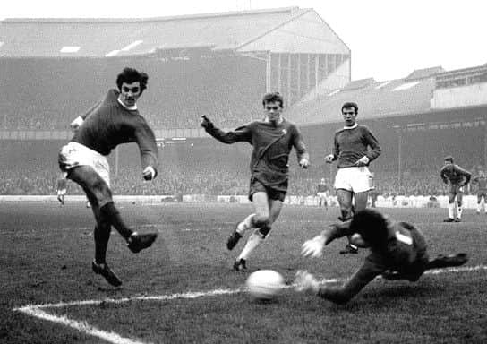 Chelsea goalkeeper Peter Bonetti (right) dives at the feet of Manchester United's George Best (left) as teammate Eddie McCreadie (second left) and United's David Sadler (second right) look on.