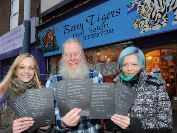 Emma Rabjohn, Elton Clough and Vicky Green of Betty Tigers in Upperthorpe with the mystery poems they have received through the post.