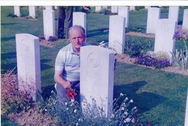 Lance Corporal Fred Adamson lays poppies at Ronnie McGrath's grave in the 1980s