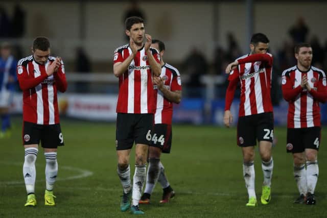 Chris Basham of Sheffield Utd leads the players in applauding the fans after the 3-3 draw at Spotland