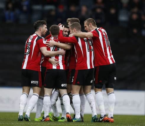 Sheffield United players mob Daniel Lafferty after his goal against Rochdale on Saturday