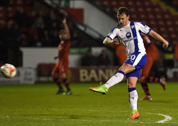 Chesterfield's Kristian Dennis volleys at goal . Pic:  Andrew Roe