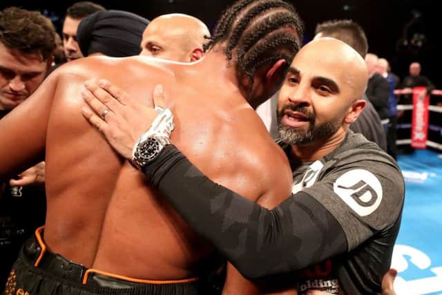 David Haye is embraced by the trainer of Tony Bellew, Dave Coldwell (right) after losing the heavyweight contest at The O2. Pix: Nick Potts/PA Wire