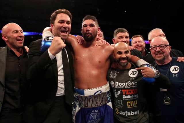 Tony Bellew celebrates victory over David Haye alongside promoter Eddie Hearn (left) and trainer Dave Coldwell (right)