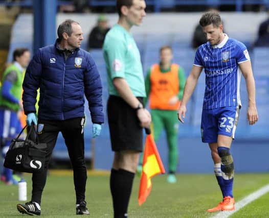 Sam Hutchinson trudges off the field in the first half  with club doctor Richard Higgins