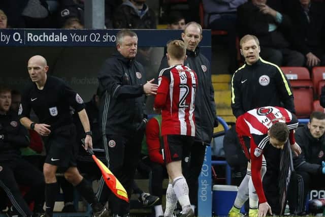 Chris Wilder shakes Mark Duffy's hand as the Blades player is replaced at Rochdale