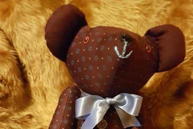 A memory teddy. Sold at the Cushion Queen stall in Crystal Peaks market which is run by Lucu Fisher. The teddy is made using an item of clothing owned by a lost loved one.