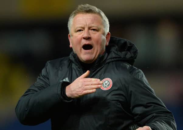 Chris Wilder celebrates after the Blades' win at Oxford United