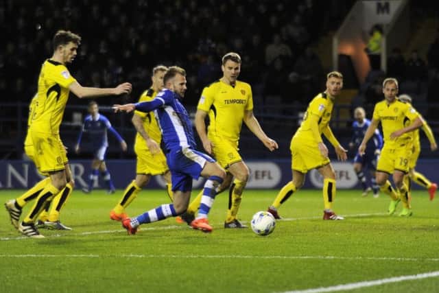 Sheffield Wednesday striker Jordan Rhodes attempts a shot, surrounded by Burton Albion players