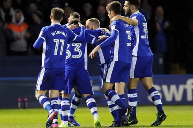 Barry Bannan (centre) helps Ross Wallace celebrate his goal