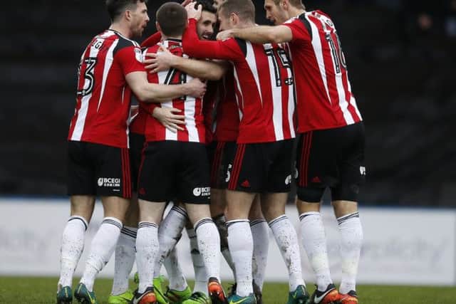 Danny Lafferty is mobbed by his team mates after scoring against Rochdale: Simon Bellis/Sportimage