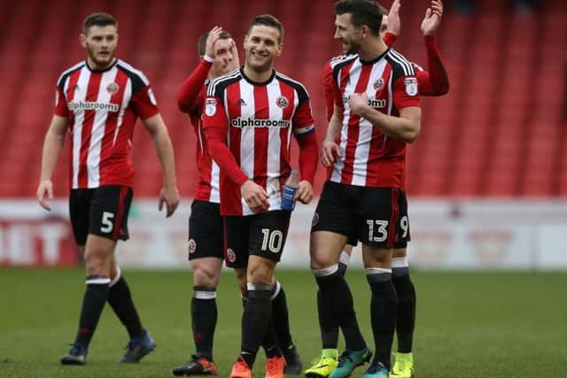 Billy Sharp and some of his Sheffield United team mates share a joke following a win for the Blades
