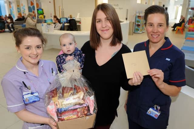 Sarah Birch (r), with her eight month duaghter Annie, from Forging Families are presenting Sheffield Children's Hospital Ward M2 staff Jo Reid-Roberts and Emma Harding with gifts after Annie was recently treated there for a kidney condition.