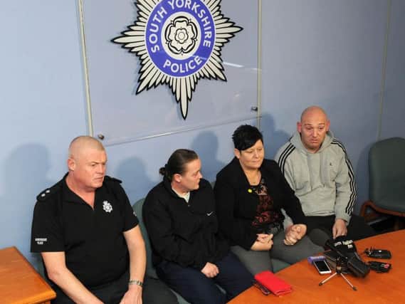 South Yorkshire Police Inspector Mark Hughes with family members during the press conference